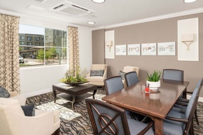Bright common area with seating and a view