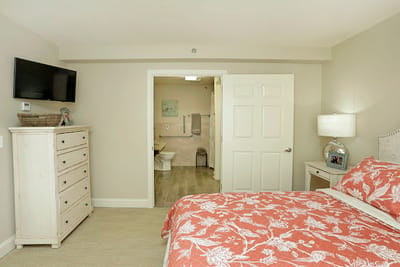 A well-decorated private room with a floral bedspread