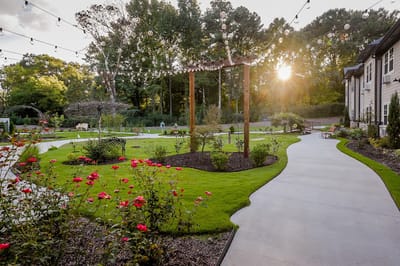 Well-manicured garden pathway with hanging lights