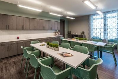 Modern activity room with tables and chairs