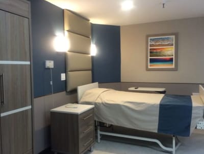 Private resident room with a bed and artwork