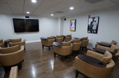 Common area with seating and a large screen