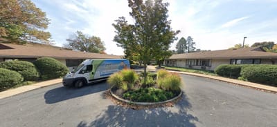 A van parked in a courtyard of a care facility