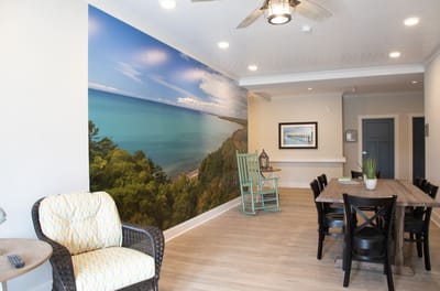 Bright common area with ocean mural and dining table