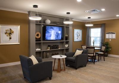 Interior common area with seating and a TV