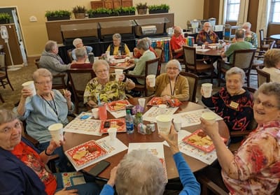 Residents celebrating with drinks at a festive activity