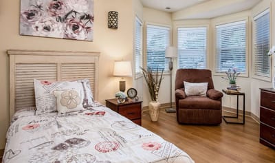 Cozy resident room with a bed and chair