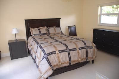 Neatly arranged bedroom with a double bed and furniture
