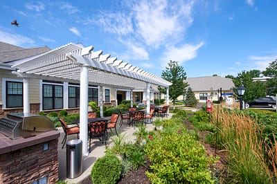 Outdoor seating area with greenery and patio
