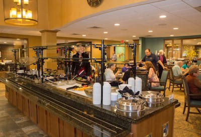 Residents dining in a bright cafeteria setting