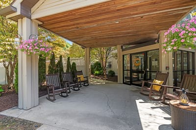 Outdoor seating area with flowering plants and entrance
