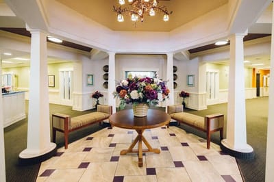 Interior view of a welcoming common area with floral arrangement