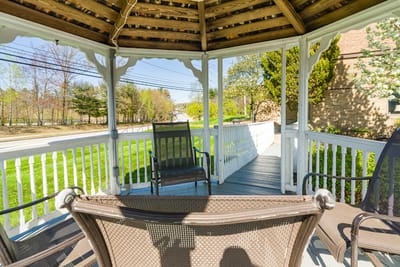 Outdoor gazebo with seating in a landscaped area