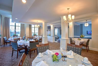 Elegant dining room set for lunch with flowers