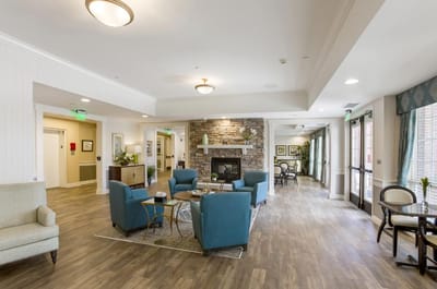 Bright common area with seating and fireplace