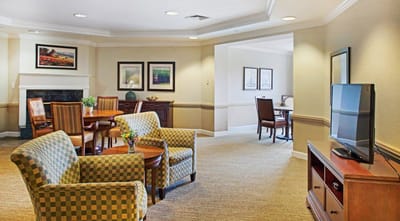 Bright common area with seating and dining tables