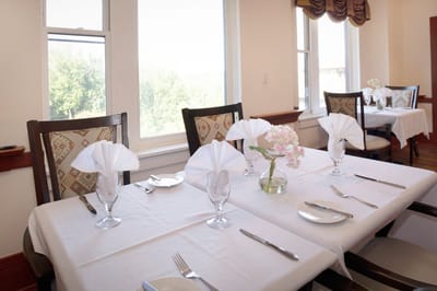 Dining table set up for a meal with flowers