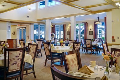 Bright dining area with tables and flowers