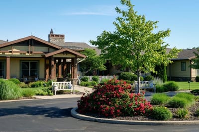 Exterior view of assisted living facility with gardens