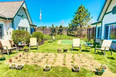 Outdoor garden area with chairs and plants