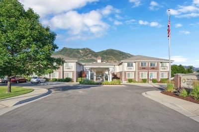 Exterior view of The Charleston at Cedar Hills with mountains