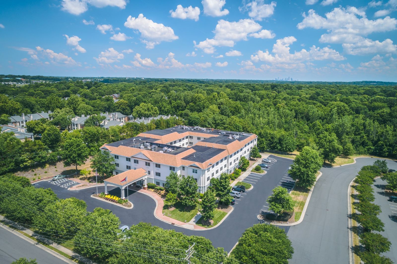 Aerial view of an assisted living facility surrounded by greenery