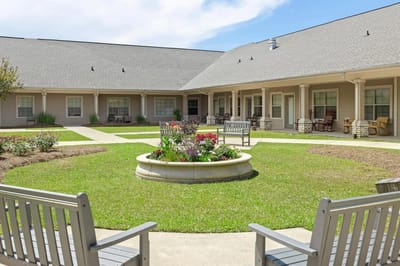 Outdoor courtyard with seating and flowerbed