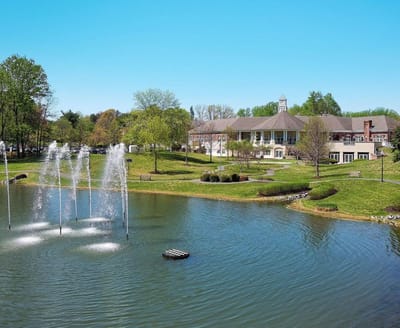 Exterior view of the facility with water fountain and landscape