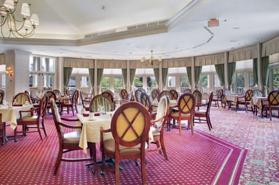 Elegant dining room with round tables and large windows