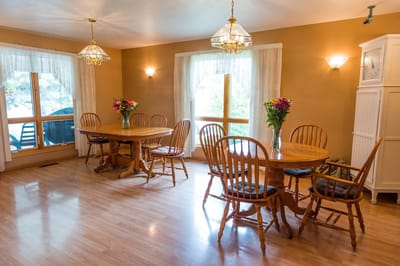 Bright dining area with wooden tables and floral arrangements