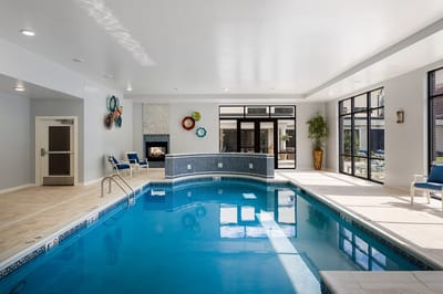Indoor swimming pool area with seating