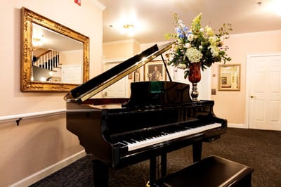 Elegant interior with a grand piano and floral arrangement
