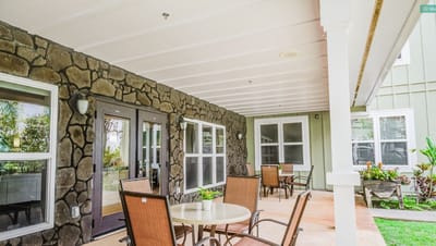 Outdoor seating area with stone walls and plants