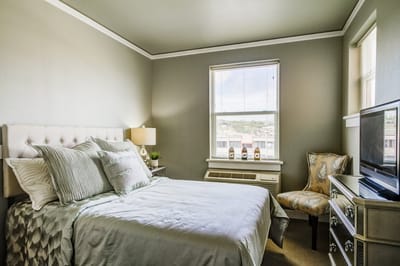 Bright, inviting private resident room with a bed