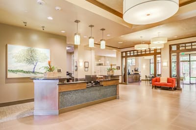 Bright lobby area with seating and a reception desk