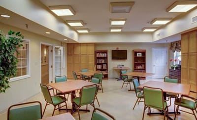 A bright common area with tables and chairs