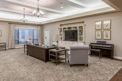 Bright common area with seating and piano
