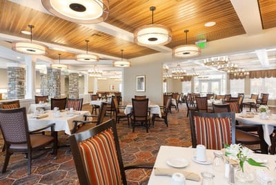 Bright dining room with tables set for meals