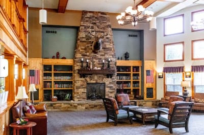 Common area with seating, fireplace, and bookshelves