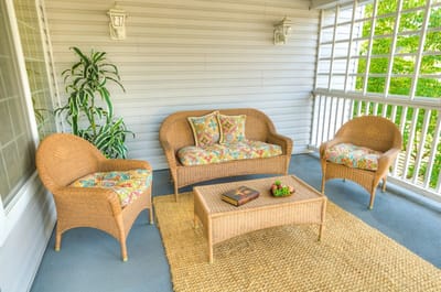 Cozy outdoor seating area with a couch and chairs