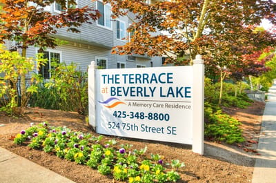 Sign for The Terrace at Beverly Lake with flowers