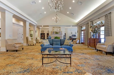 Bright common area with seating and a chandelier