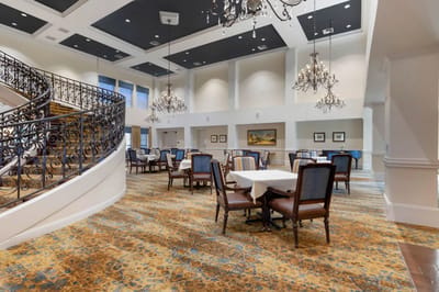Elegant dining room with ornate chandeliers and seating