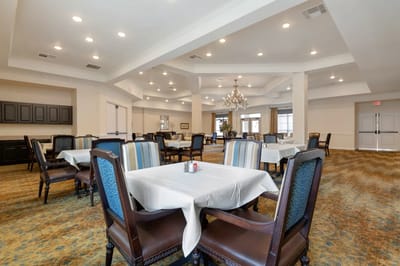 Bright dining room with tables and chairs set for meals