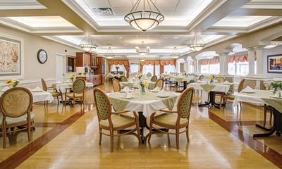 Elegant dining room setup with tables and flowers