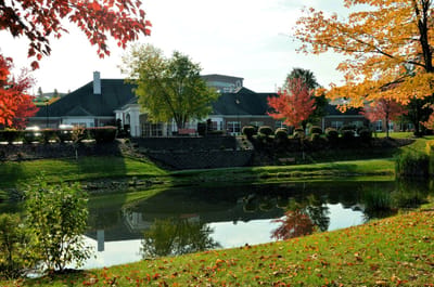 Exterior view of the facility surrounded by vibrant fall foliage