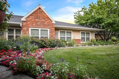 Exterior view of a senior living facility with gardens