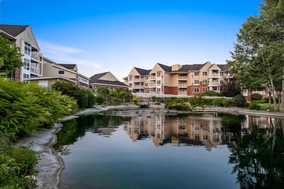 Scenic view of assisted living facility by a pond