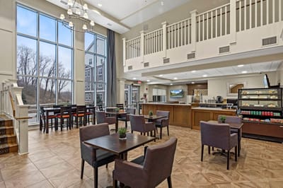 Bright common area with seating and large windows