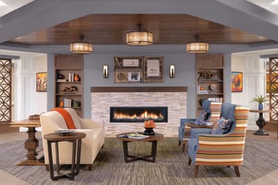 Bright and welcoming common area with seating and fireplace